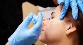 Woman Having Botox Treatment At Beauty Clinic