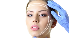 Beauty treatment of the young beautiful female face, doctor's ha