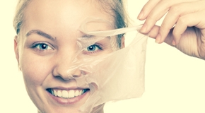 girl removing facial peel off mask