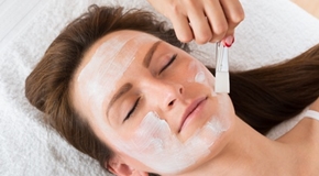 Therapist Applying Face Mask To Woman
