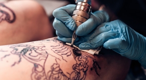 Closeup tattoo artist fill circuit tattooing