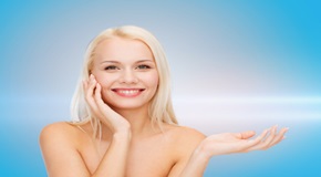 smiling woman holding imaginary lotion jar
