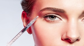 close-up of a woman doing an injection under the eyebrow