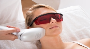 Woman Undergoing Laser Treatment At Salon